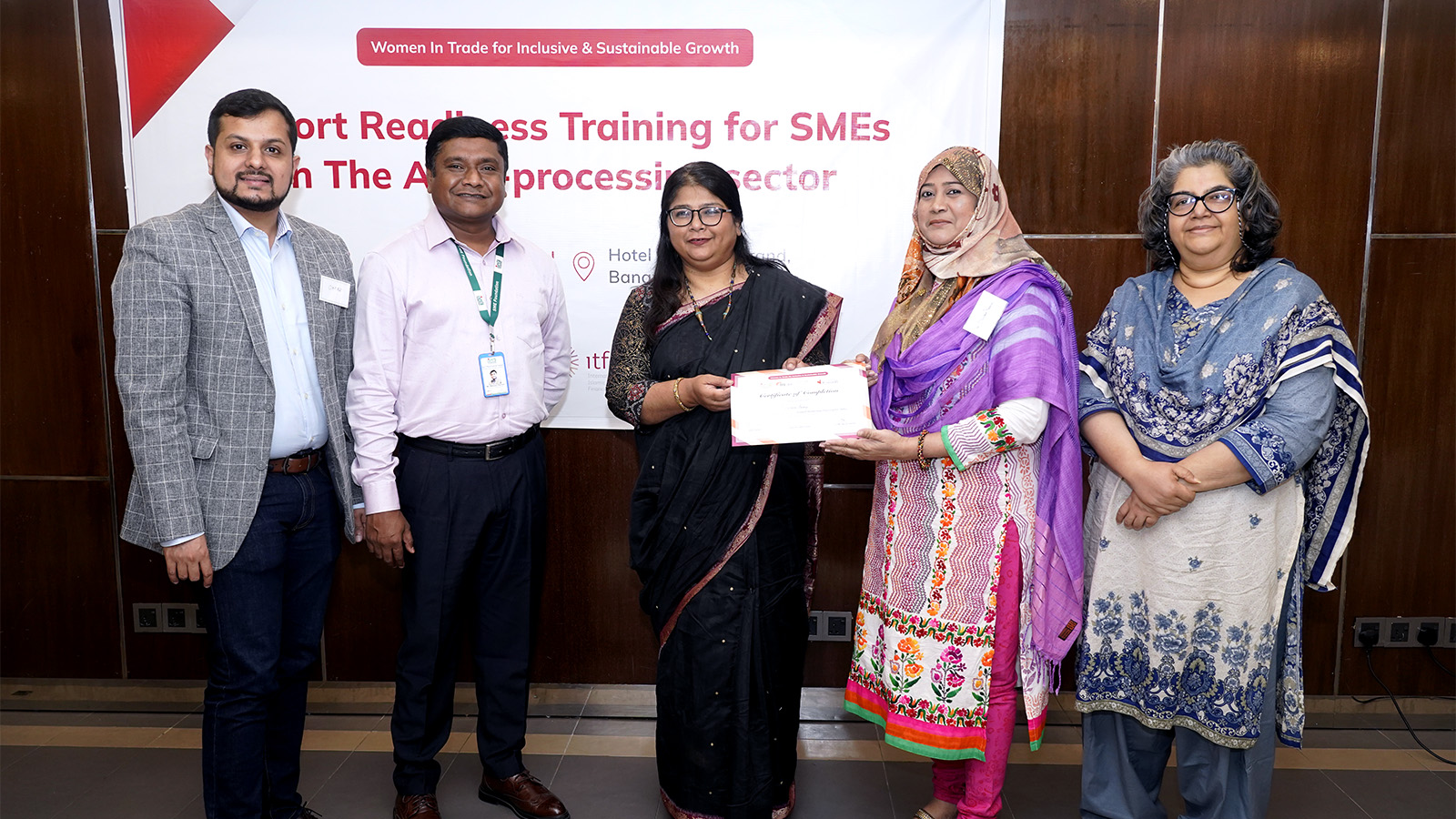 A participant at the event receiving certificate from the trainers