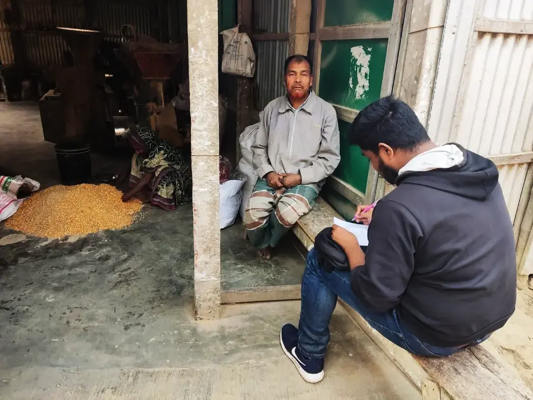 Interview with a Chatal operator with a woman laborer in the background in Dewanganj